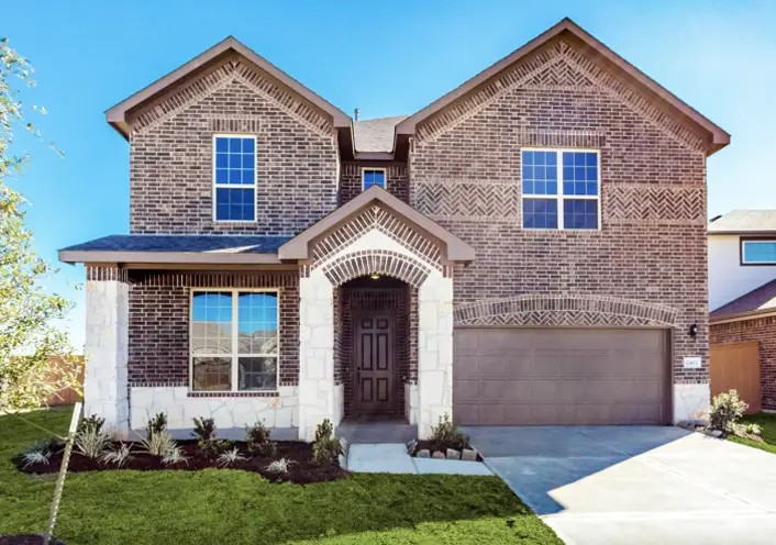Outdoor view of exterior of a two-story home with clean drive way and well-maintained lawn